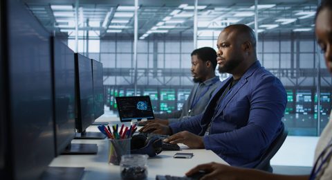 portrait-happy-server-room-worker-developing-disaster-recovery-plans