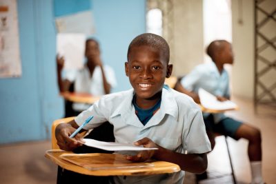 boy holding white paper boy holding white paper