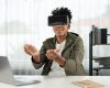 african-american-looking-through-vr-holding-interesting-data-meta-contrivance_31965-566576