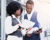 portrait-young-african-businesswoman-showing-something-digital-tablet-her-colleague_23-2148190652