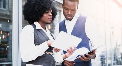 portrait-young-african-businesswoman-showing-something-digital-tablet-her-colleague_23-2148190652